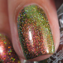Load image into Gallery viewer, A complex red-bronze to gold to green-blue shifting multichrome nail polish filled with gold holographic microglitter