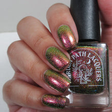 Load image into Gallery viewer, A complex red-bronze to gold to green-blue shifting multichrome nail polish filled with gold holographic microglitter