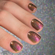 Load image into Gallery viewer, A complex red-bronze to gold to green-blue shifting multichrome nail polish filled with gold holographic microglitter
