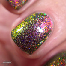 Load image into Gallery viewer, A complex red-bronze to gold to green-blue shifting multichrome nail polish filled with gold holographic microglitter