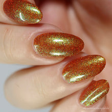 Load image into Gallery viewer, Red holographic microglitter and blue/green shifting shimmer accent a burnt orange jelly base.