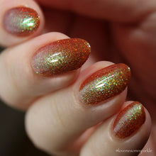 Load image into Gallery viewer, Red holographic microglitter and blue/green shifting shimmer accent a burnt orange jelly base.