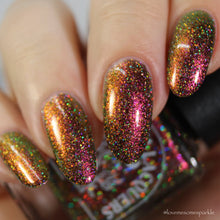 Load image into Gallery viewer, A complex red-bronze to gold to green-blue shifting multichrome nail polish filled with gold holographic microglitter