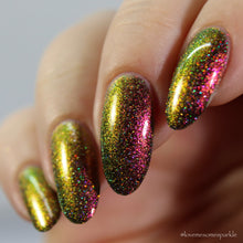 Load image into Gallery viewer, A complex red-bronze to gold to green-blue shifting multichrome nail polish filled with gold holographic microglitter