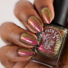 Load image into Gallery viewer, A complex red-bronze to gold to green-blue shifting multichrome nail polish filled with gold holographic microglitter