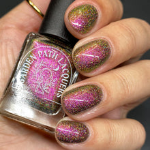 Load image into Gallery viewer, A complex red-bronze to gold to green-blue shifting multichrome nail polish filled with gold holographic microglitter