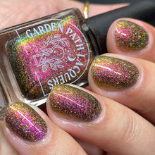 Load image into Gallery viewer, A complex red-bronze to gold to green-blue shifting multichrome nail polish filled with gold holographic microglitter