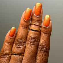 Load image into Gallery viewer, Red holographic microglitter and blue/green shifting shimmer accent a burnt orange jelly base.