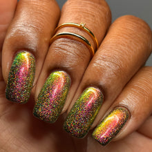 Load image into Gallery viewer, A complex red-bronze to gold to green-blue shifting multichrome nail polish filled with gold holographic microglitter