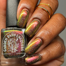 Load image into Gallery viewer, A complex red-bronze to gold to green-blue shifting multichrome nail polish filled with gold holographic microglitter